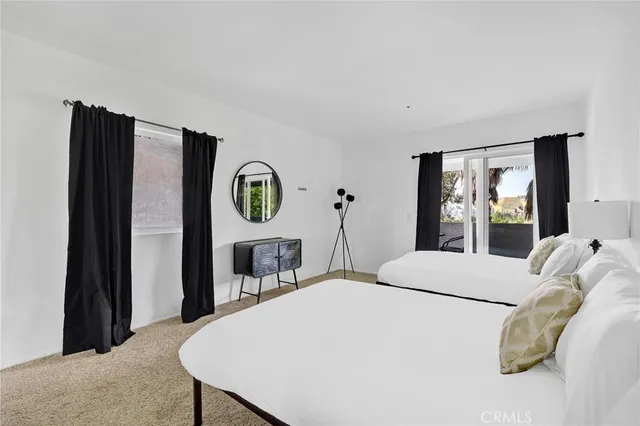 a bedroom with furniture and a window