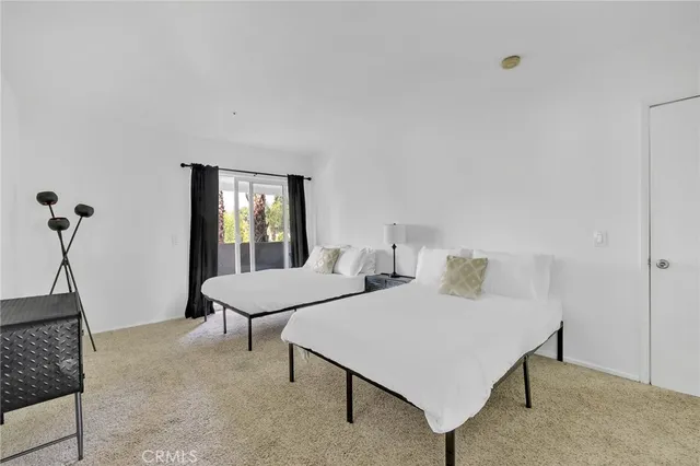 a patio with table and chairs and potted plants