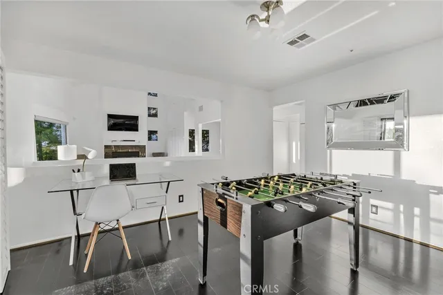a view of a workspace with furniture and window