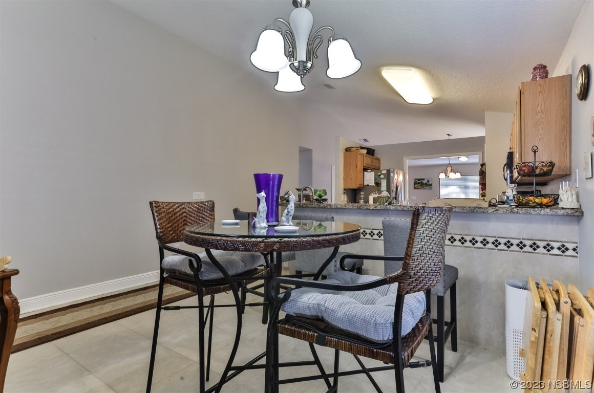 811 Star Reef Lane Edgewater, FL 32132 - Photo 15 of 35 a view of a dining room with furniture and wooden floor