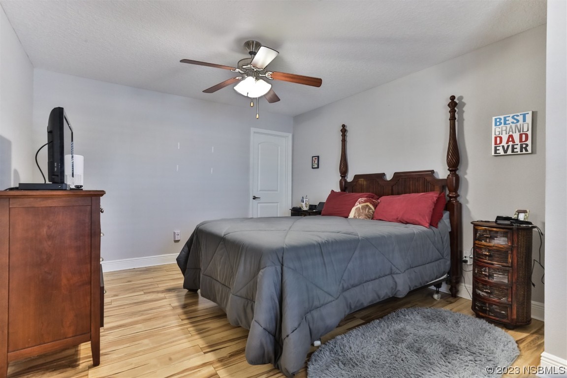 811 Star Reef Lane Edgewater, FL 32132 - Photo 19 of 35 a bedroom with a bed and wooden floor