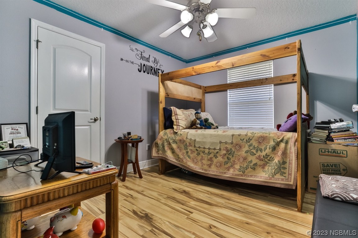 811 Star Reef Lane Edgewater, FL 32132 - Photo 27 of 35 a bedroom with bed and a flat tv screen on dresser