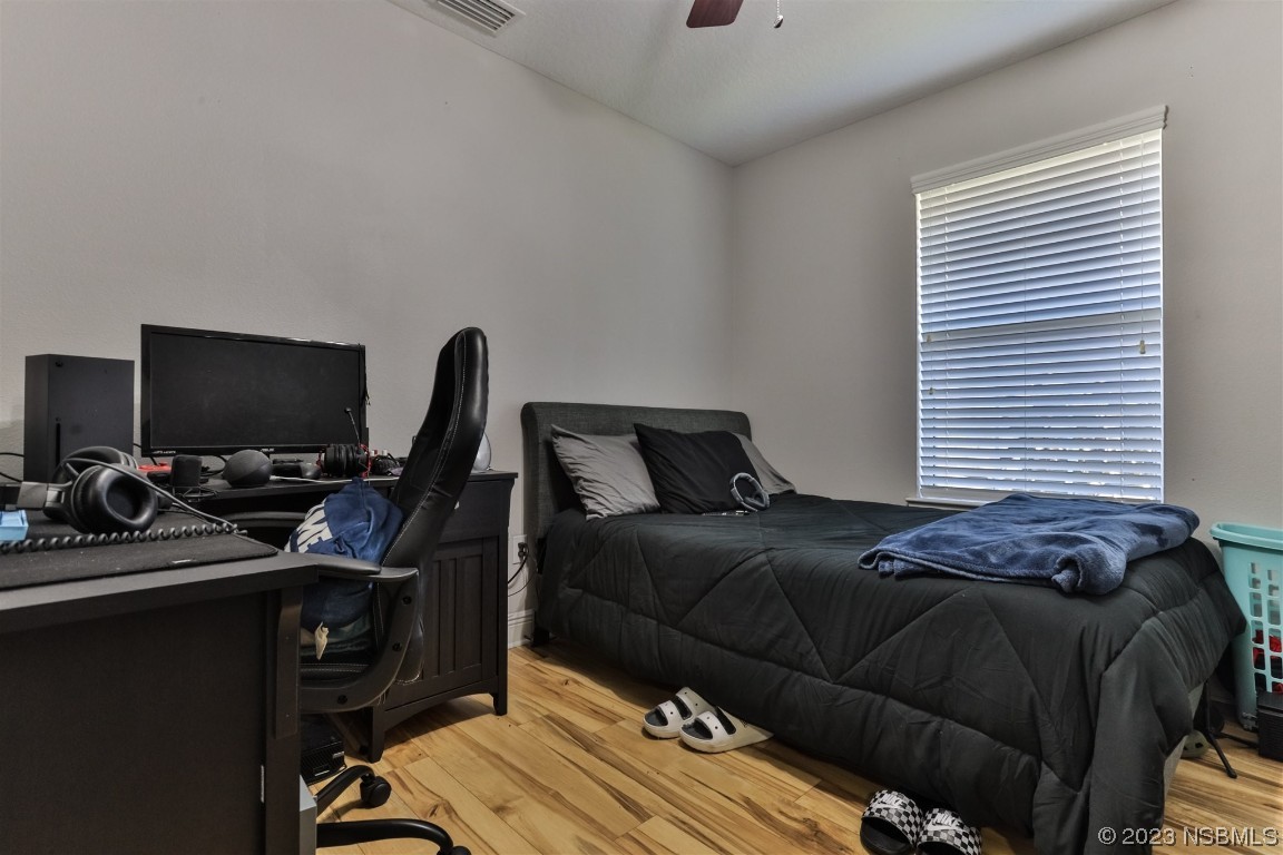 811 Star Reef Lane Edgewater, FL 32132 - Photo 28 of 35 a bedroom with a bed and a flat screen tv