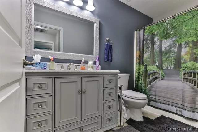 a bathroom with a sink toilet and mirror