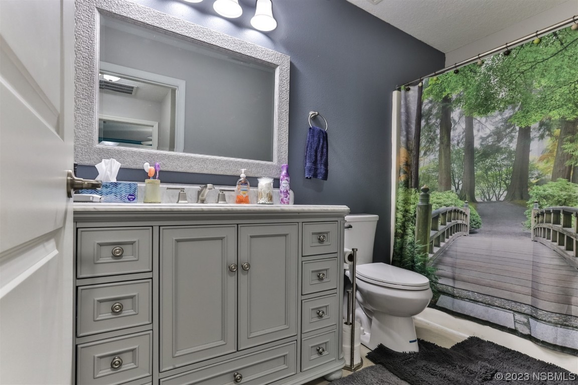 811 Star Reef Lane Edgewater, FL 32132 - Photo 29 of 35 a bathroom with a sink toilet and mirror