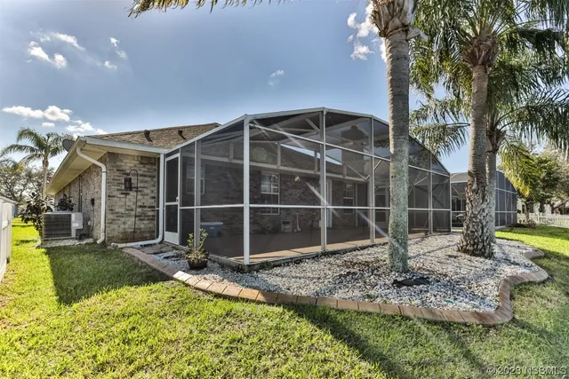 a view of a house with backyard and sitting area