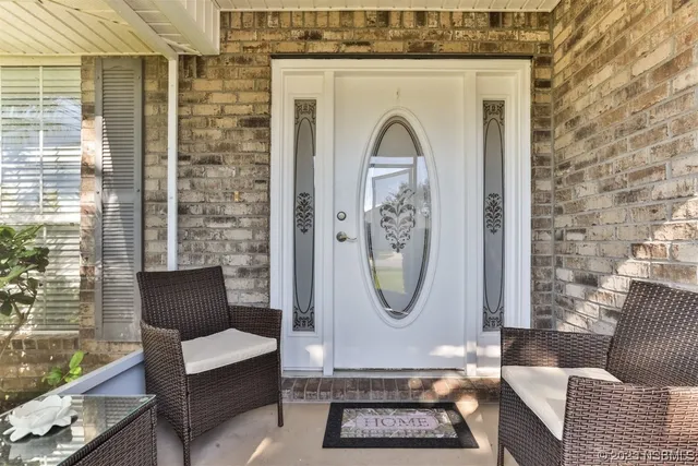 a living room with furniture a mirror a clock and a window