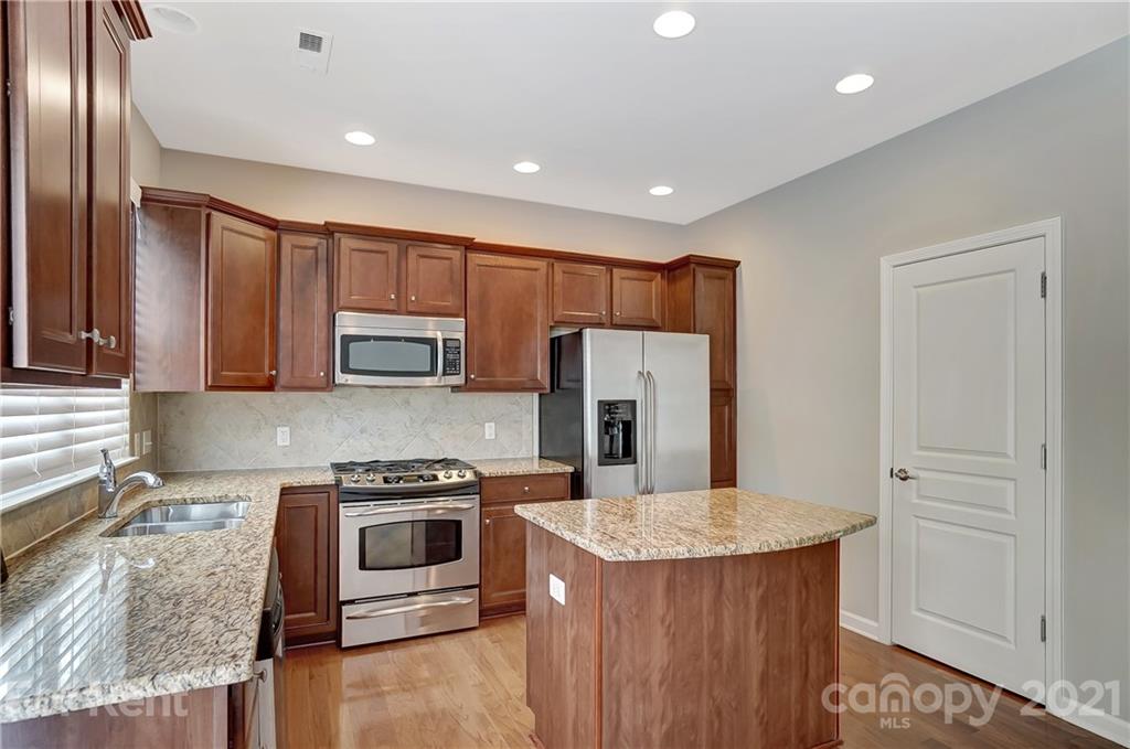 905 Lyndley Drive Fort Mill, SC 29708 - Photo 11 of 28 a kitchen with stainless steel appliances granite countertop a refrigerator a stove top oven a sink and dishwasher