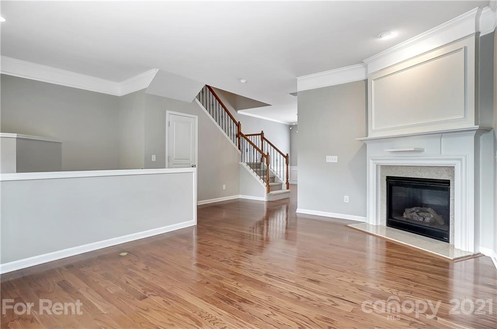 905 Lyndley Drive Fort Mill, SC 29708 - Photo 5 of 28 a view of an empty room with wooden floor fire place