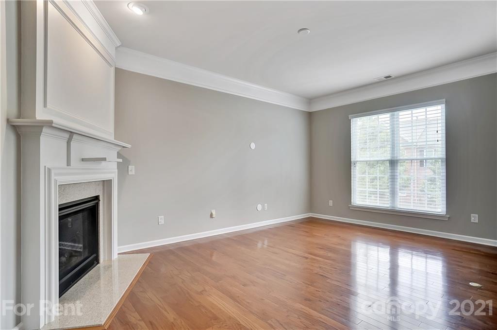 905 Lyndley Drive Fort Mill, SC 29708 - Photo 6 of 28 a view of an empty room with wooden floor fireplace and a window