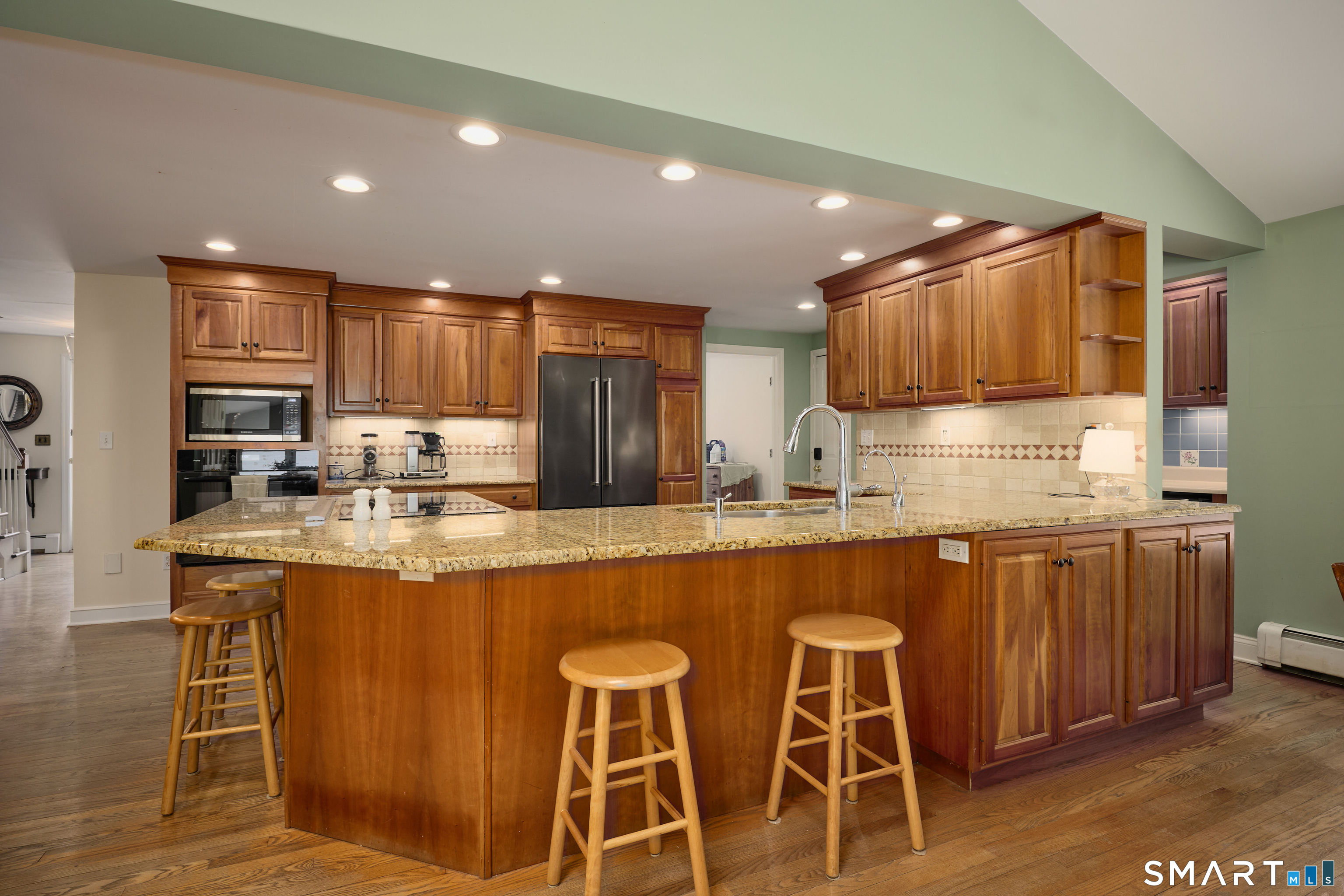 41 Old Mill Road Ridgefield, CT 06877 - Photo 12 of 33 a kitchen with stainless steel appliances granite countertop wooden cabinets and sink