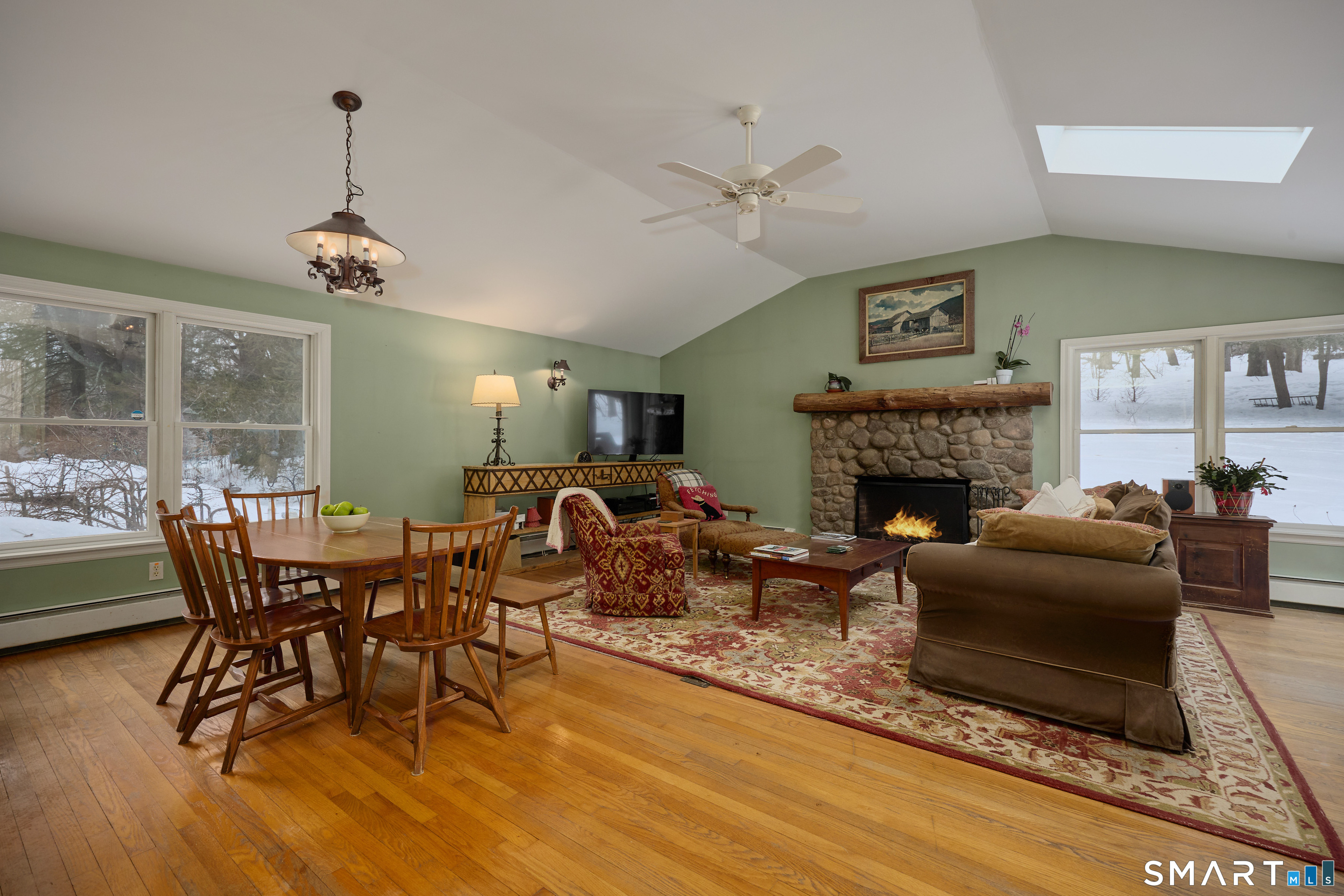 41 Old Mill Road Ridgefield, CT 06877 - Photo 14 of 33 a living room with furniture a dining table and a fireplace