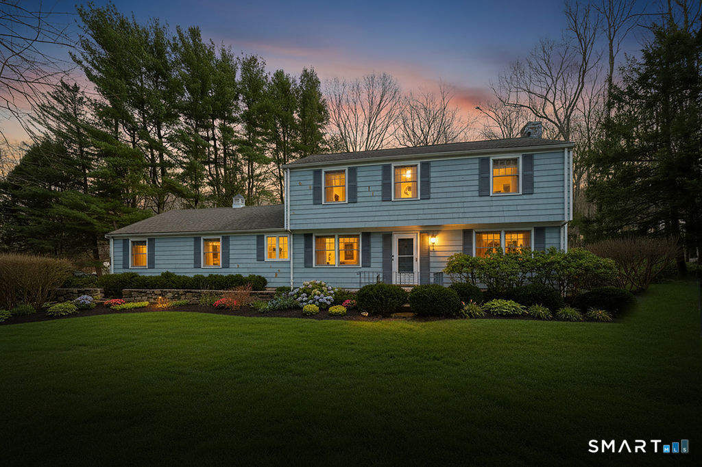 41 Old Mill Road Ridgefield, CT 06877 - Photo 2 of 33 a front view of a house with a garden and trees