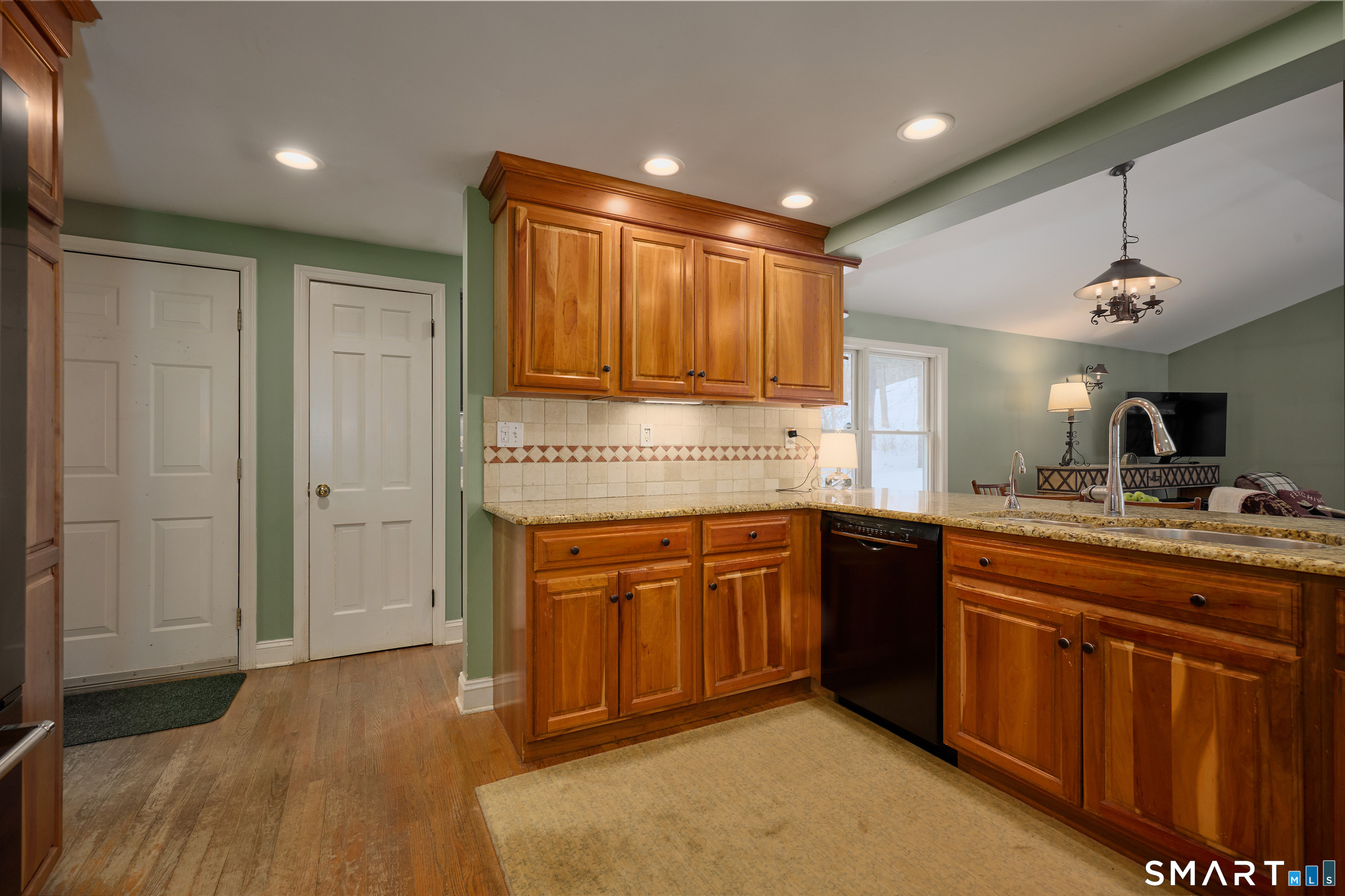 41 Old Mill Road Ridgefield, CT 06877 - Photo 9 of 33 a kitchen with kitchen island granite countertop wooden cabinets and white appliances