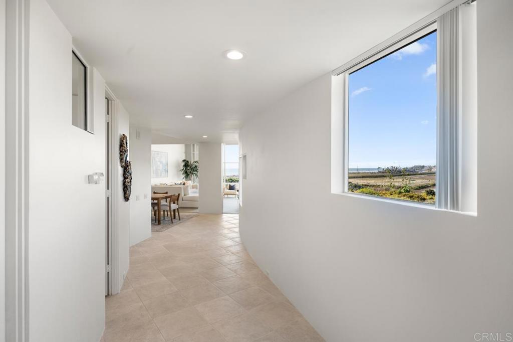 170 Solana Point Circle Solana Beach, CA 92075 - Photo 24 of 68 a view of a hallway with a dining table and chairs