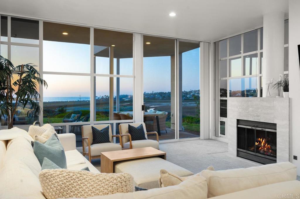 170 Solana Point Circle Solana Beach, CA 92075 - Photo 29 of 68 a living room with furniture large windows and a fireplace