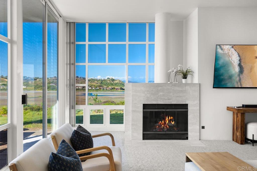 170 Solana Point Circle Solana Beach, CA 92075 - Photo 32 of 68 a living room with furniture a fireplace and a large window