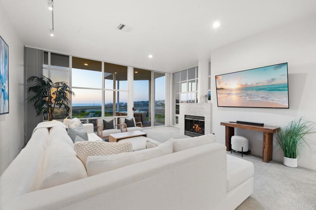 170 Solana Point Circle Solana Beach, CA 92075 - Photo 40 of 68 a living room with furniture a flat screen tv and a large window