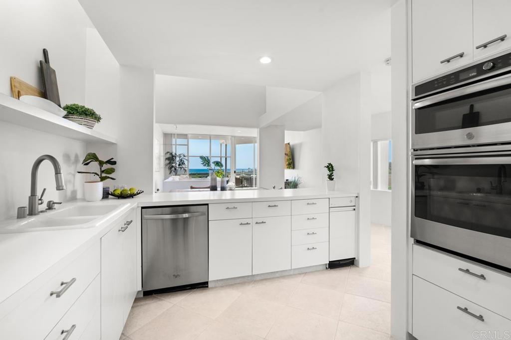 170 Solana Point Circle Solana Beach, CA 92075 - Photo 49 of 68 a kitchen with white cabinets stainless steel appliances and sink