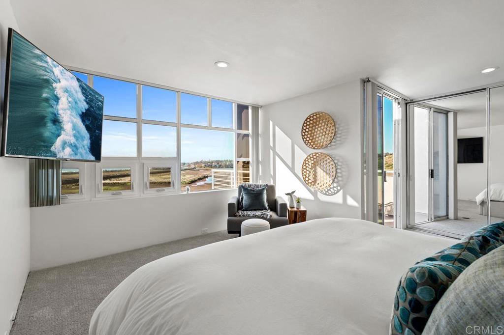170 Solana Point Circle Solana Beach, CA 92075 - Photo 52 of 68 a bedroom with a large bed and a large window