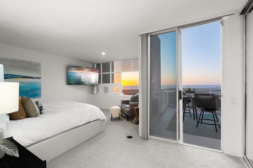 170 Solana Point Circle Solana Beach, CA 92075 - Photo 56 of 68 a bedroom with a bed and a chandelier