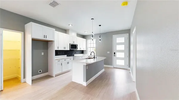 a kitchen with stainless steel appliances a refrigerator and a stove top oven