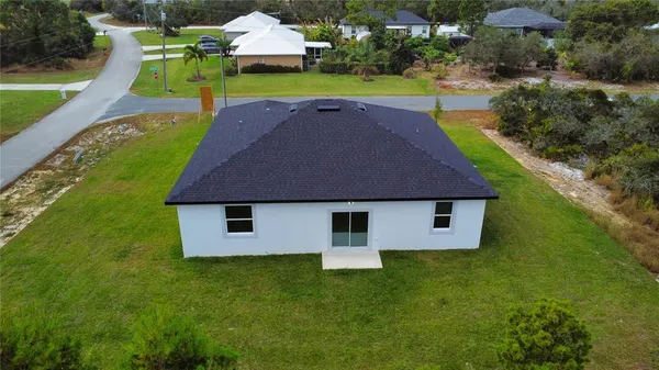 an aerial view of a house with swimming pool garden and patio