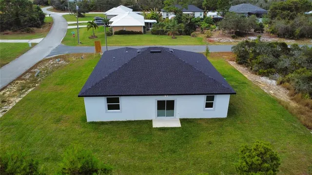 an aerial view of a house with swimming pool garden and patio