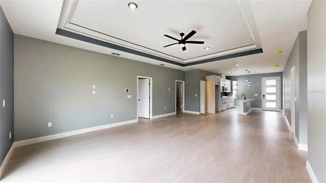 a view of a livingroom with a ceiling fan and window
