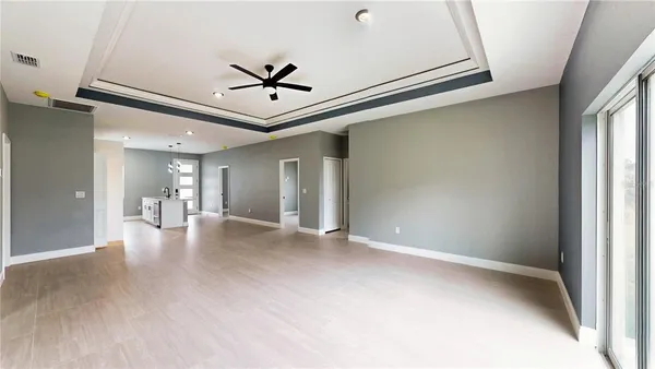 a view of a livingroom with a ceiling fan and window