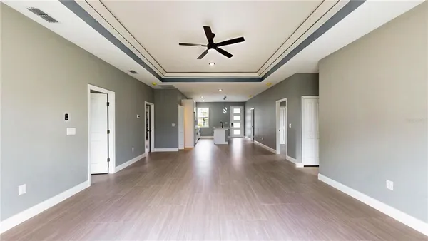 a view of a hallway with wooden floor