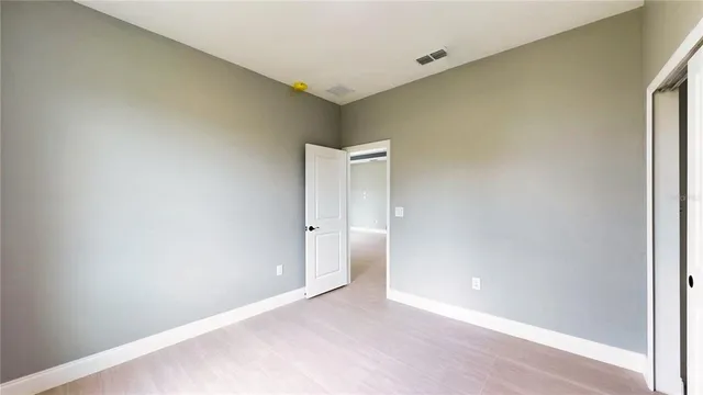 a view of an empty room and closet area