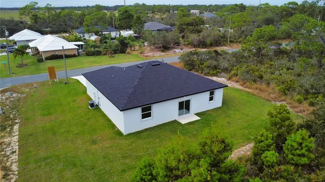 aerial view of a house with a yard