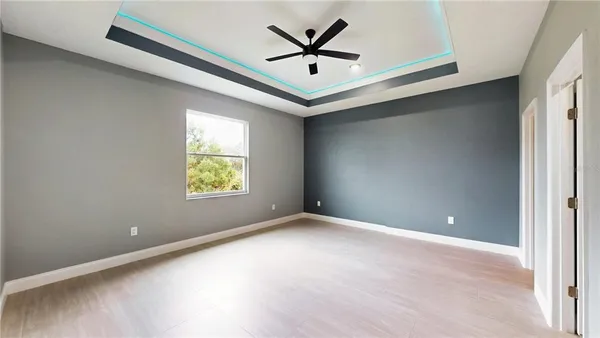 a view of a livingroom with a ceiling fan and window