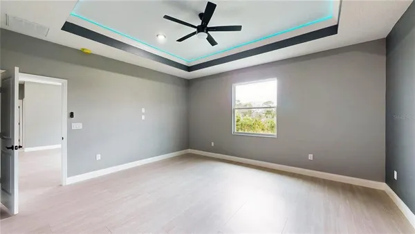 a view of a livingroom with a ceiling fan and window