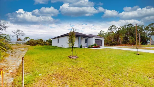 a house view with swimming pool and trees in the background