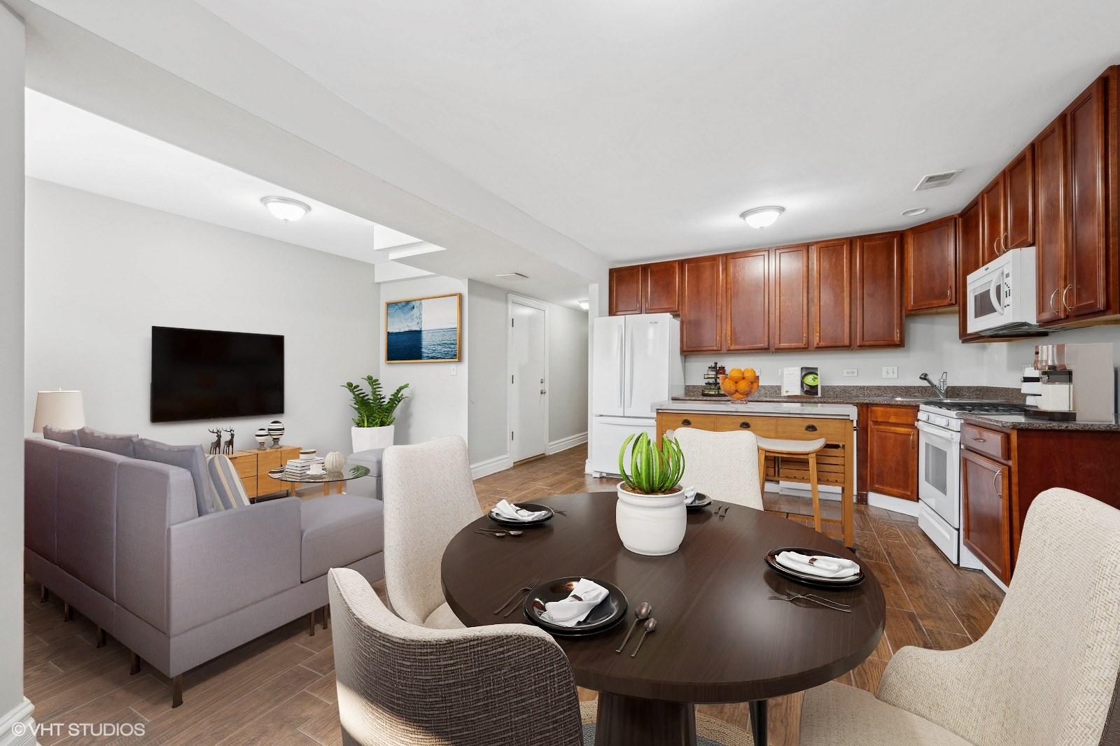 2256 West Adams Street, Unit G Chicago, IL 60612 - Photo 5 of 11 a living room with white couches and a dining table with kitchen view