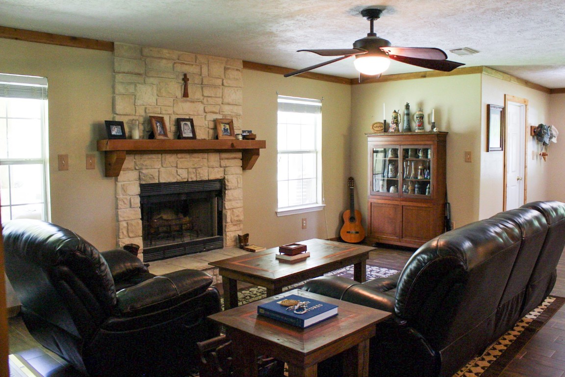 1076 West Branding Iron Road Weimar, TX 78962 - Photo 12 of 24 a living room with furniture a dining table and a fireplace