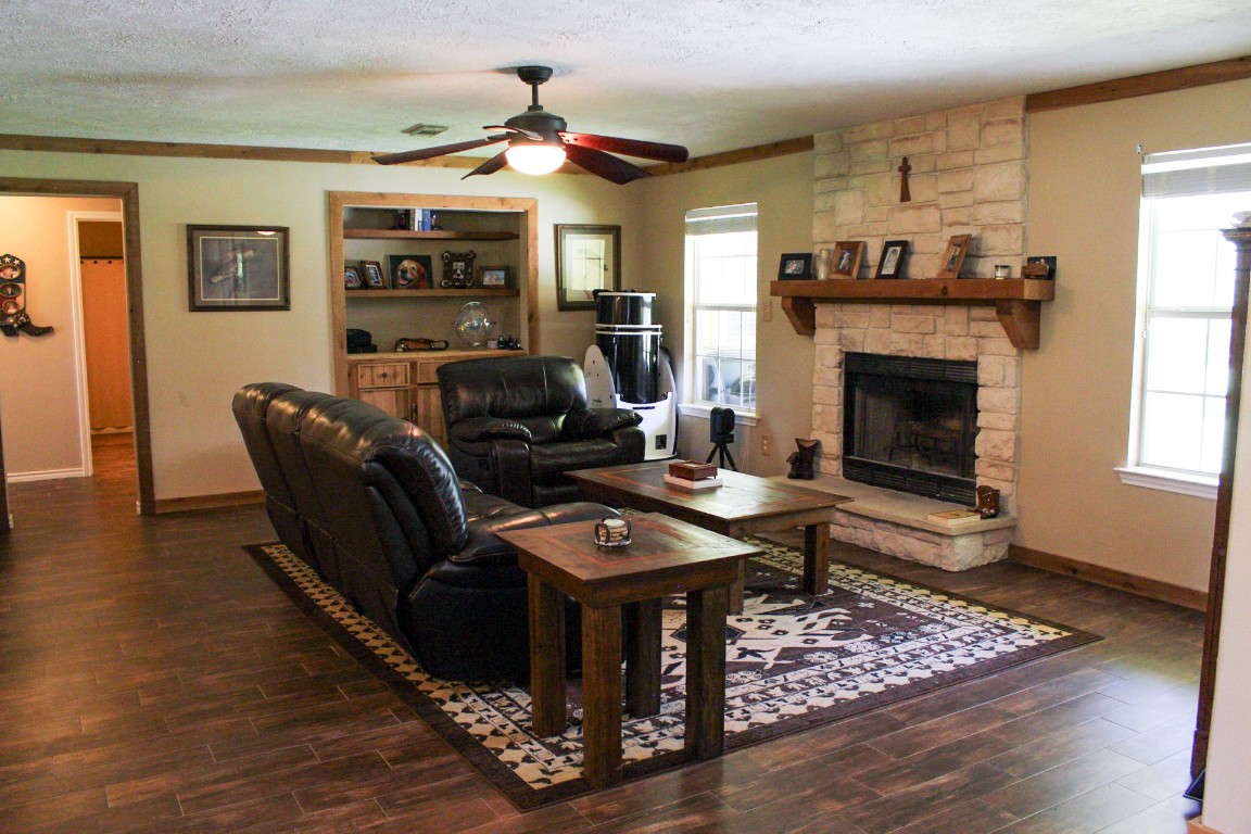 1076 West Branding Iron Road Weimar, TX 78962 - Photo 13 of 24 a living room with furniture a fireplace and wooden floor