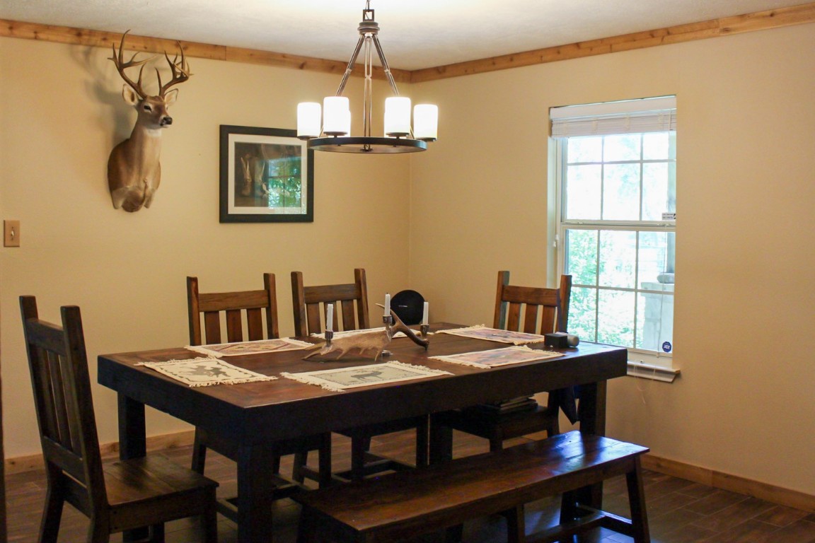 1076 West Branding Iron Road Weimar, TX 78962 - Photo 14 of 24 a view of a dining room with furniture window and wooden floor