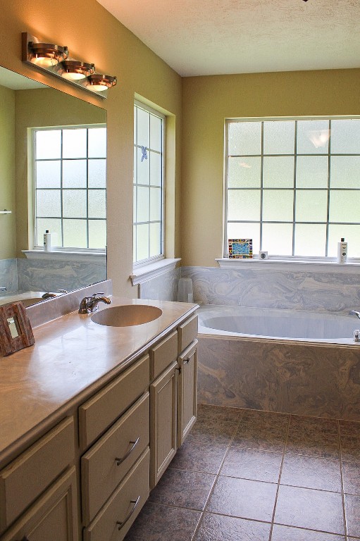 1076 West Branding Iron Road Weimar, TX 78962 - Photo 17 of 24 a bathroom with a sink and a large mirror