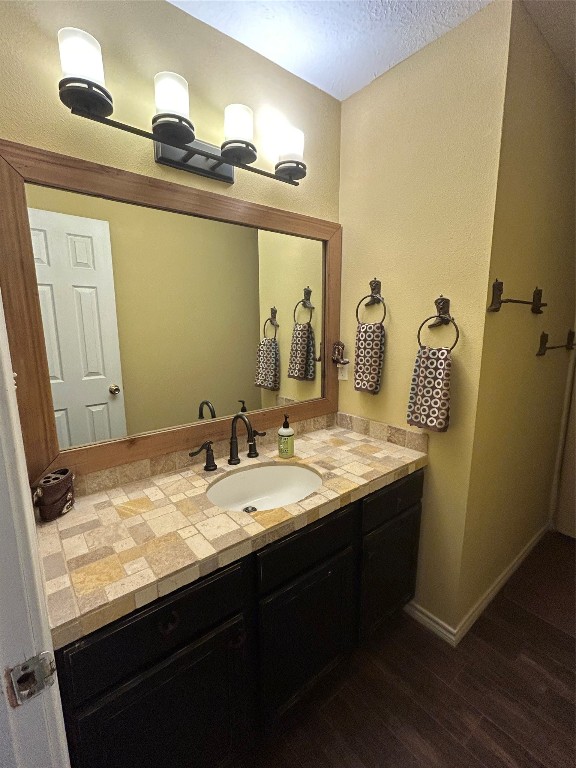 1076 West Branding Iron Road Weimar, TX 78962 - Photo 18 of 24 a bathroom with a granite countertop sink and a mirror