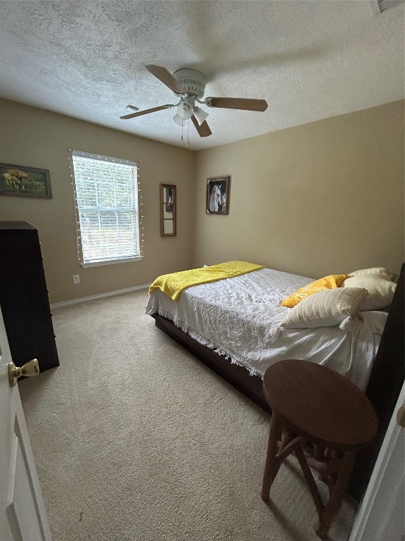 1076 West Branding Iron Road Weimar, TX 78962 - Photo 19 of 24 a bedroom with a bed and a chair