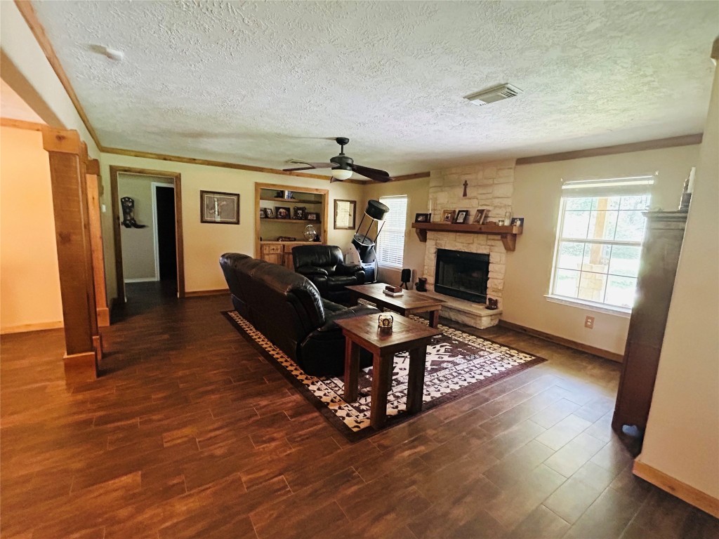 1076 West Branding Iron Road Weimar, TX 78962 - Photo 20 of 24 a living room with furniture windows and a fireplace
