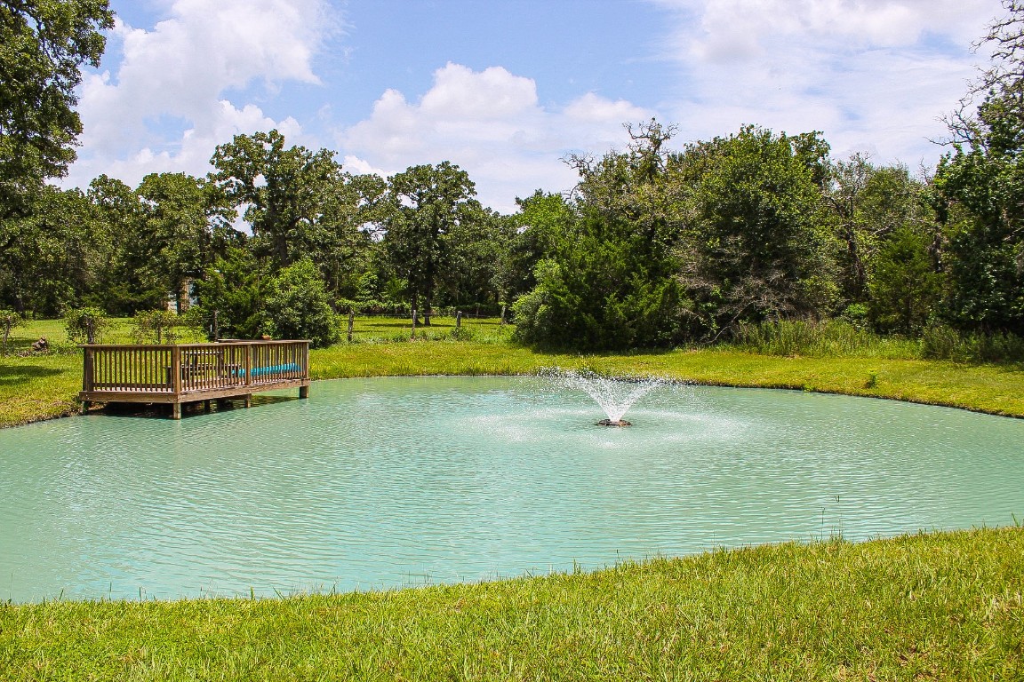 1076 West Branding Iron Road Weimar, TX 78962 - Photo 2 of 24 a view of a swimming pool with an outdoor space and seating area