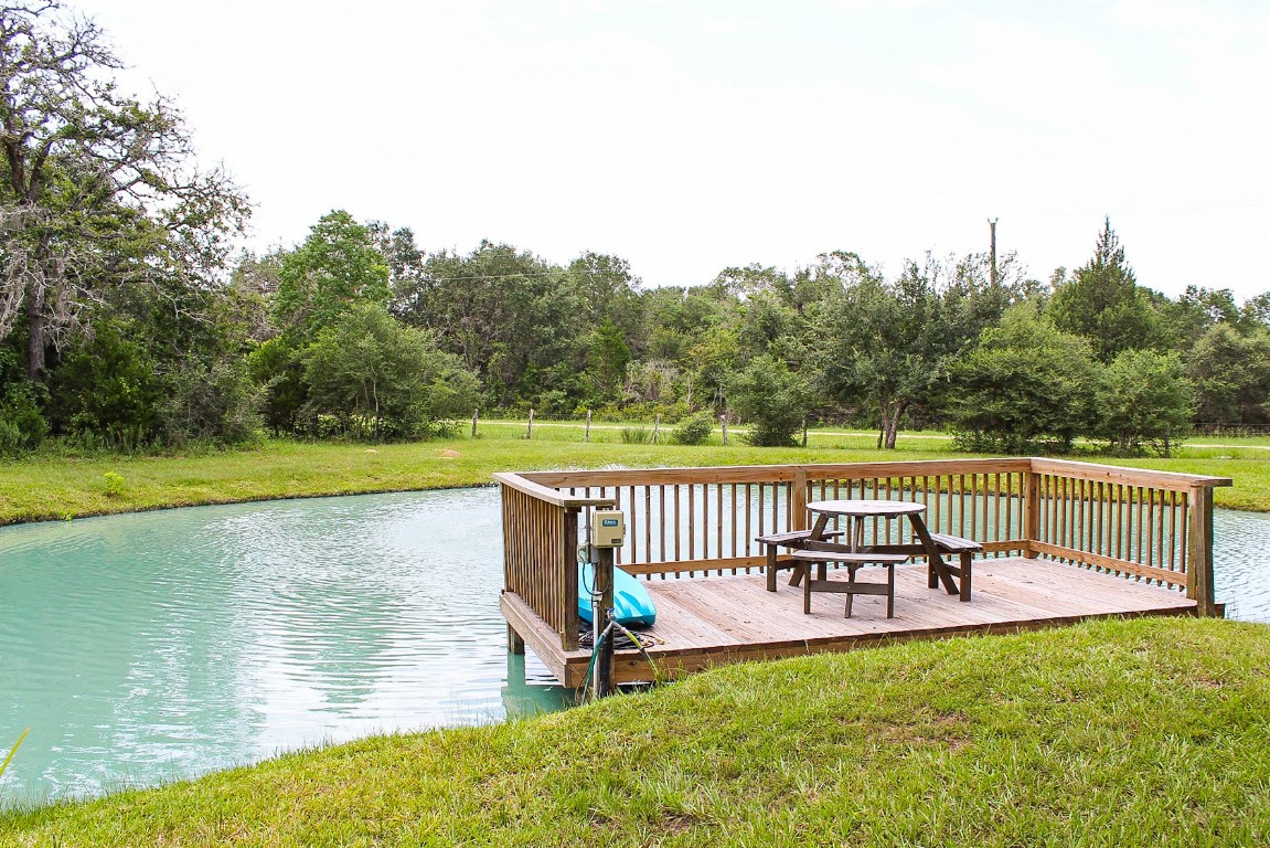 1076 West Branding Iron Road Weimar, TX 78962 - Photo 3 of 24 a view of a lake with table and chairs