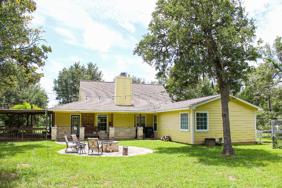 1076 West Branding Iron Road Weimar, TX 78962 - Photo 5 of 24 a front view of a house with a garden and sitting area