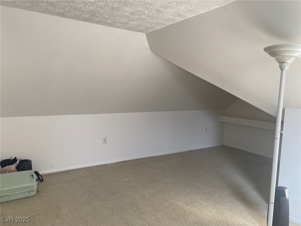 735 Canyon Street Ely, NV 89301 - Photo 13 of 20 Upstairs Bonus room with a textured ceiling, carpet, and vaulted ceiling