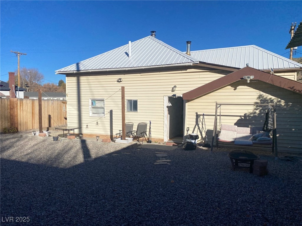 735 Canyon Street Ely, NV 89301 - Photo 19 of 19 Rear view of house with a metal roof and a patio area