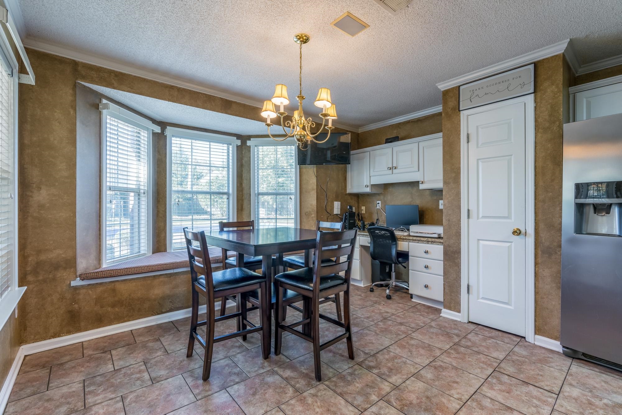 8599 Brer Fox Cove Memphis, TN 38018 - Photo 13 of 25 a view of a dining room with furniture and window